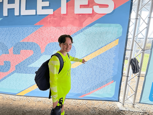 Evelyn Dickerson pointing at wall.