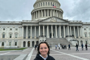 Evelyn Dickerson standing in front of U.S.. Capitol building.